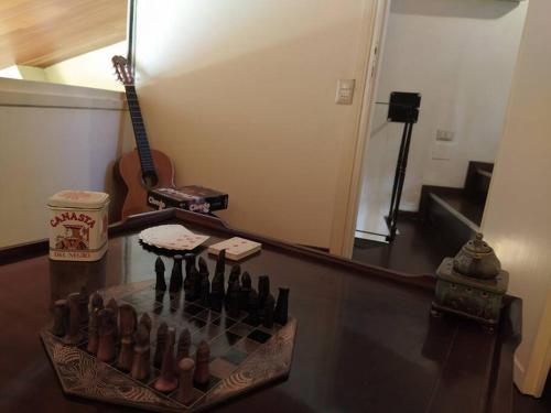 a room with a guitar and a tray of bottles at Il Vecchio e il Mare in Fiumicino