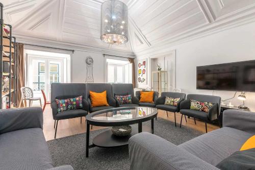 a living room with a couch and a table at Bairro Alto Palace Special for Groups up to 24 guests in Lisbon