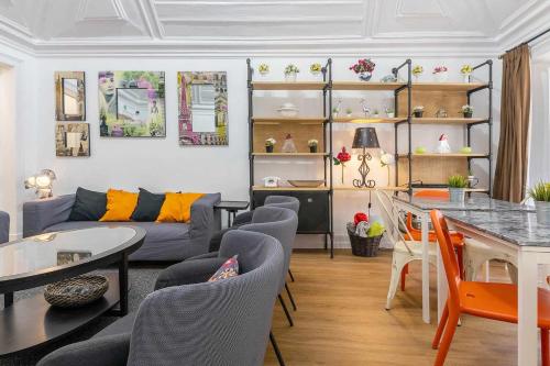 a living room with a couch and a table and chairs at Bairro Alto Palace Special for Groups up to 24 guests in Lisbon