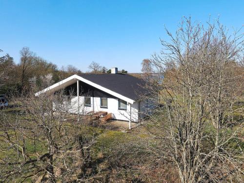 a white house sitting on top of a hill at 7 person holiday home in Skals-By Traum in Skals