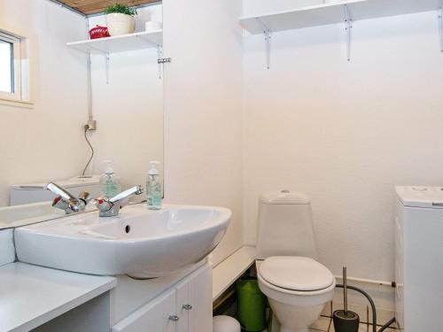 a white bathroom with a sink and a toilet at Holiday home Haderslev XLV in Haderslev