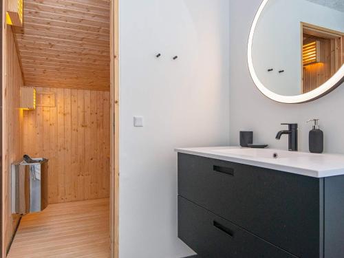 a bathroom with a sink and a mirror at 6 person holiday home in Lemvig-By Traum in Lemvig