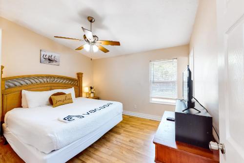 a bedroom with a bed and a flat screen tv at Happy Pelican in Panama City Beach
