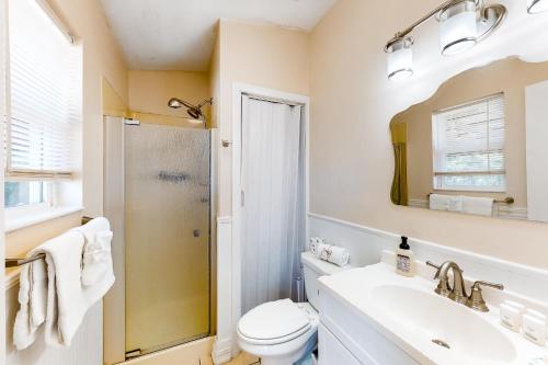 a bathroom with a toilet and a sink and a shower at Happy Pelican in Panama City Beach