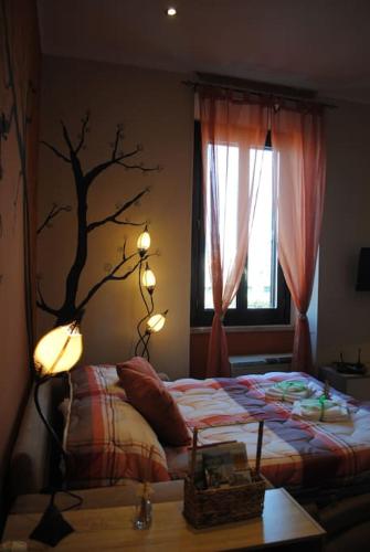 a bedroom with a bed with a tree on the wall at Casa degli Alberi in Fiumicino
