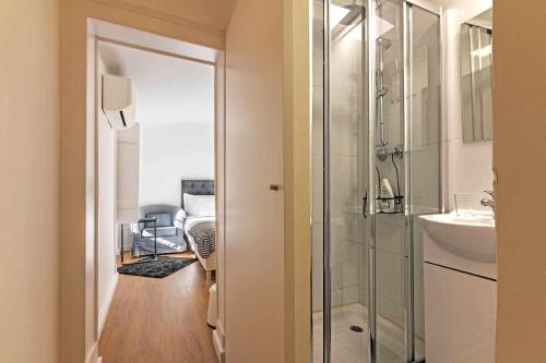 a bathroom with a glass shower and a sink at Bairro Alto Palace Special for Groups up to 24 guests in Lisbon