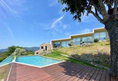 a house on a hill with a swimming pool at Casa do Vale de Cerdeiras in Ancede