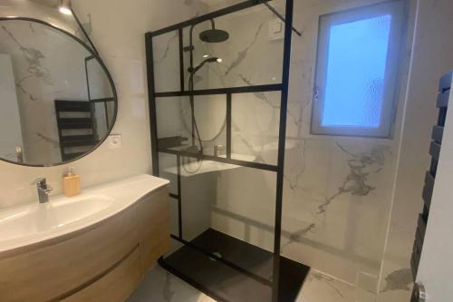 a bathroom with a shower and a sink and a mirror at * Logement Haut de gamme Centre * in Perpignan