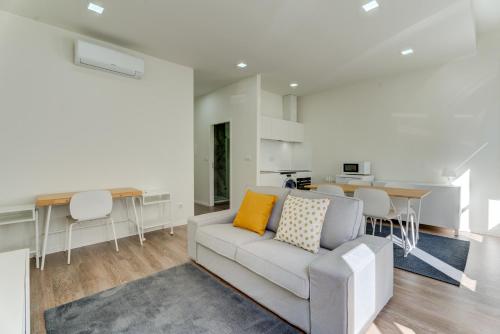 a living room with a couch and a table at Carmo Flats Historic Center - Collection by Perpetual Relax in Braga