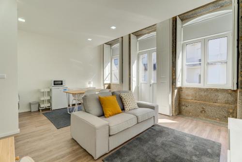 a living room with a couch and a table at Carmo Flats Historic Center - Collection by Perpetual Relax in Braga