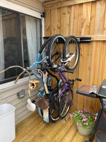 a bike is hanging on a wooden wall at Destin-y 30A Beach Retreat Self Checkin - Huge Private Backyard Deck with Outdoor Shower in Santa Rosa Beach