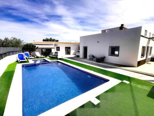 a swimming pool in the backyard of a house at Casas Caiado Two Houses with swimming POOL in Faro