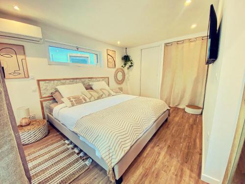 - une chambre avec un lit et une télévision à écran plat dans l'établissement Mini Villa Indépendante à 350m de la mer (LAX), à Lucciana