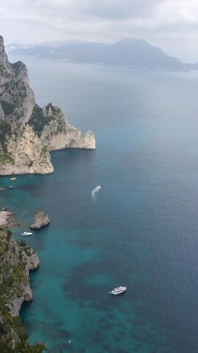 an island with two boats in a large body of water at La Casetta in Capri