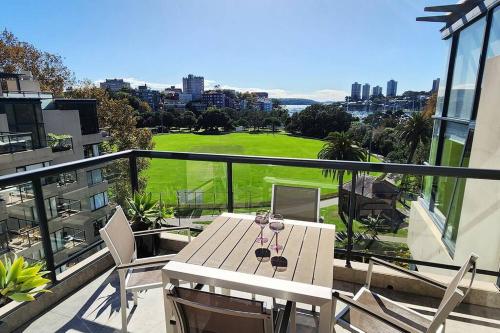 a patio with a table and chairs on a balcony at Penthouse with Private Terrace, Parking + 2 Pools in Sydney