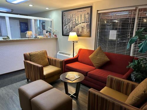 a waiting room with a couch and two chairs at NATION'S INN of Wake County - Raleigh Crabtree in Raleigh
