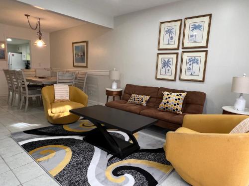 a living room with a couch and chairs and a table at Spacious, cozy villa w/parking in Coligny Villas in Hilton Head Island