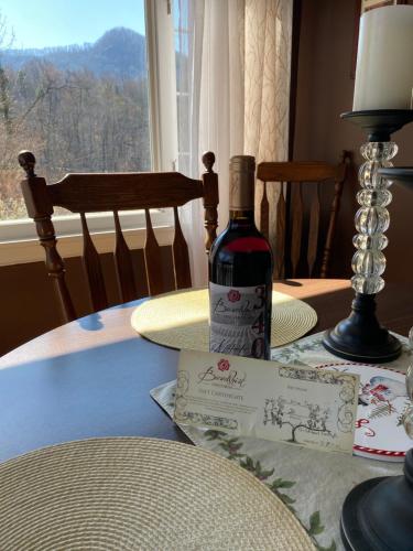 a bottle of wine sitting on top of a table at Grafton Lodge in Lake Lure