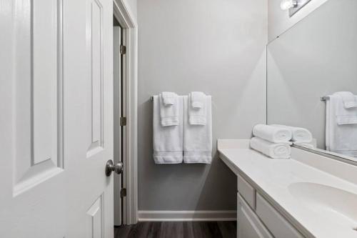 a white bathroom with a sink and a mirror at Beach Place at True Blue - Close to the beach! in Pawleys Island