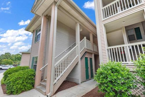 a house with a staircase on the side of it at Beach Place at True Blue - Close to the beach! in Pawleys Island