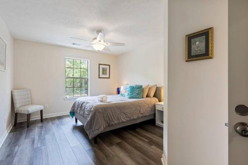 a bedroom with a bed and a table and a window at Beach Place at True Blue - Close to the beach! in Pawleys Island