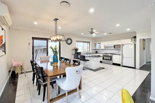 a kitchen and dining room with a table and chairs at Doncaster Renovated 5BD/4BR Brick Home Parking WiFi in Doncaster