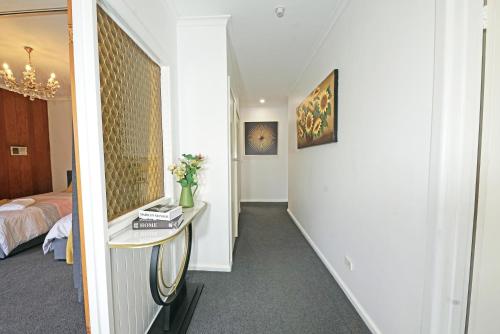 a room with a hallway with a bed and a table at Doncaster Renovated 5BD/4BR Brick Home Parking WiFi in Doncaster