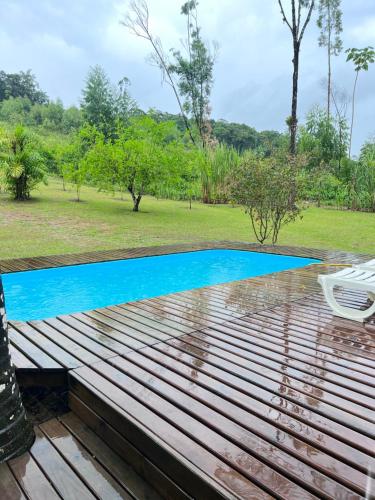 a view of a swimming pool from the deck of a house at Sítio do Vô Pisco in Camboriú