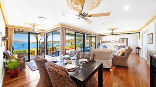 a dining room with a view of the ocean at North View - St Huberts in Daleys Point