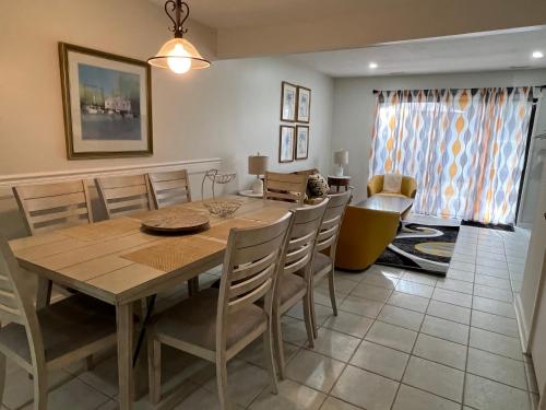 a dining room with a wooden table and chairs at Spacious, cozy villa w/parking in Coligny Villas in Hilton Head Island