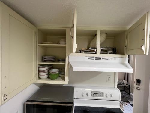 a kitchen with white cabinets and a stove at Spacious, cozy villa w/parking in Coligny Villas in Hilton Head Island