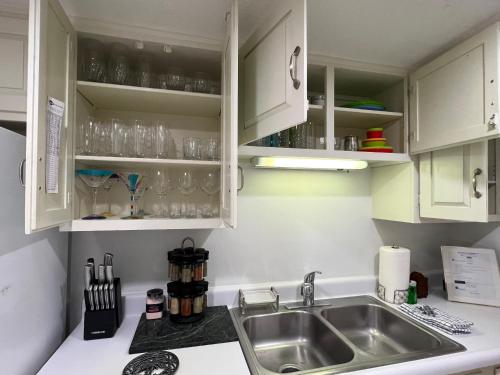 a kitchen with white cabinets and a sink at Spacious, cozy villa w/parking in Coligny Villas in Hilton Head Island