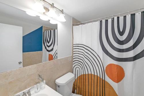 a bathroom with a toilet and a shower curtain at 21st floor condo in the center of Atlanta in Atlanta