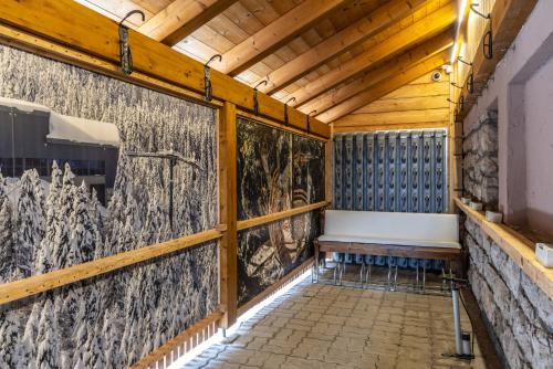 a wooden room with a bench on a wall at Garden Wellness Hotel S in Andalo