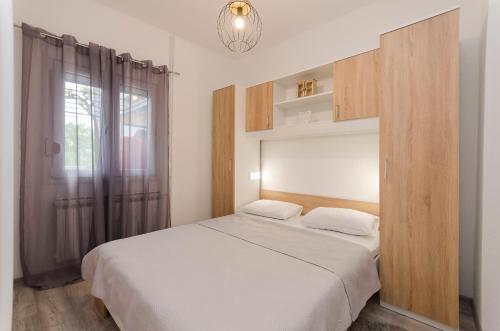 a bedroom with a large bed and a window at Apartment Maja with Jacuzzi in Rupe