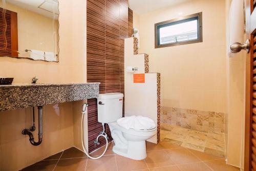 a bathroom with a toilet and a sink at Kata Silver Sand in Kata Beach