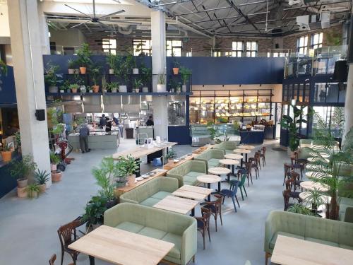 a restaurant with tables and chairs and people in the background at Junibino Hotel Hongdae in Seoul