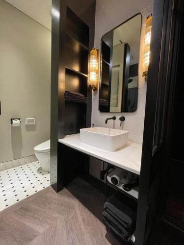a bathroom with a white sink and a toilet at Junibino Hotel Hongdae in Seoul