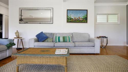 a living room with a couch and a coffee table at Bayview Escape Woy Woy Bay in Woy Woy