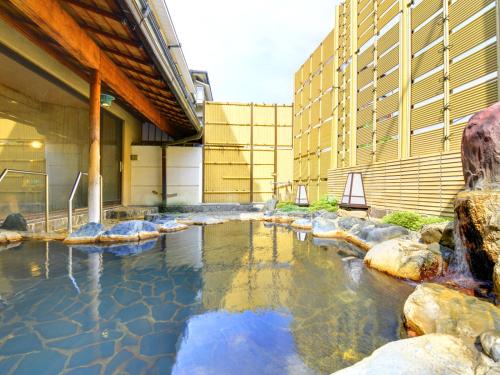 una piscina d'acqua di fronte a un edificio di Furuya Ryokan ad Atami