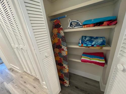 a closet with white shutters and a tie at Spacious, cozy villa w/parking in Coligny Villas in Hilton Head Island