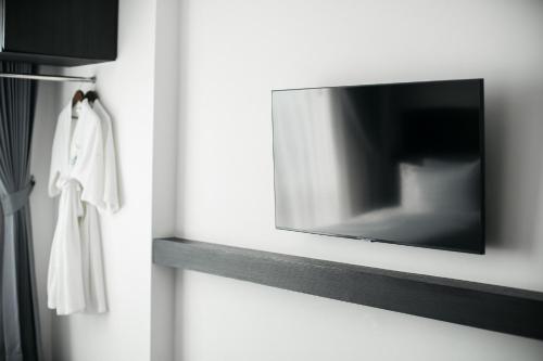 a flat screen tv hanging on a wall at SureStay Hotel by Best Western Vientiane in Vientiane