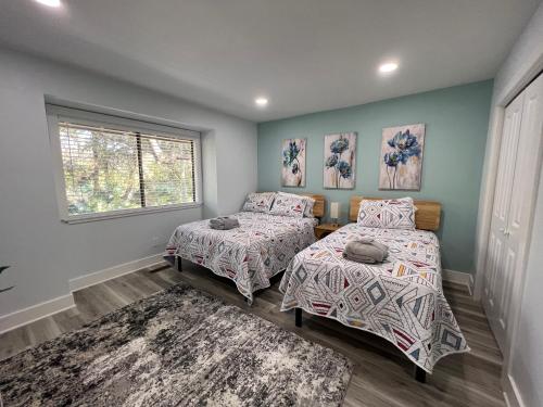 a bedroom with two beds and a window at Spacious, cozy villa w/parking in Coligny Villas in Hilton Head Island