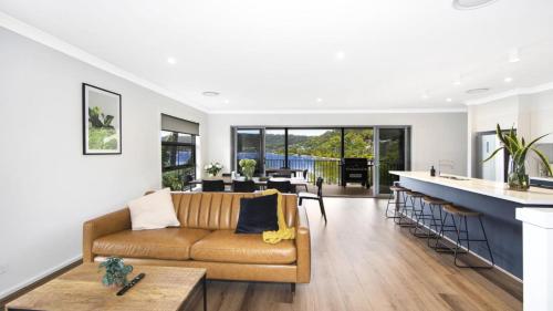 a living room with a couch and a bar at Bay Edge - Tascott in Point Clare