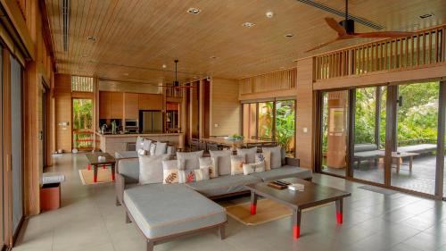 a living room with a couch and a table at Sri Panwa Phuket Luxury Pool Villa Hotel - SHA Plus in Panwa Beach