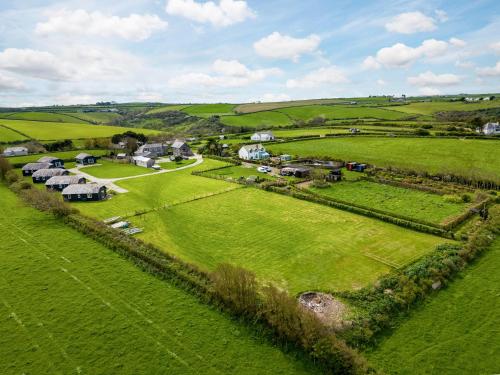 an aerial view of a farm with houses in a field at Harbour Lodge in Port Isaac