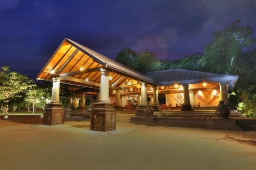 a house with lights on it at night at Kaveri Resort Sigiriya in Sigiriya