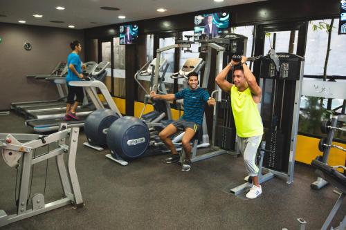 two people working out in a gym at Catalonia Yucatan Beach - All Inclusive in Puerto Aventuras