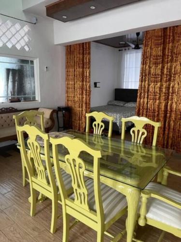 a dining room with a table and chairs and a bed at Experience Colombo like a local in Colombo