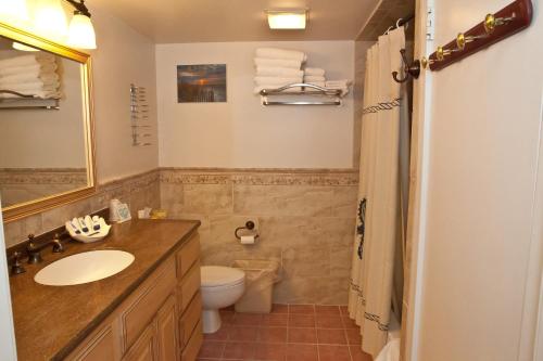 a bathroom with a sink and a toilet at Watson's Regency Suites in Ocean City